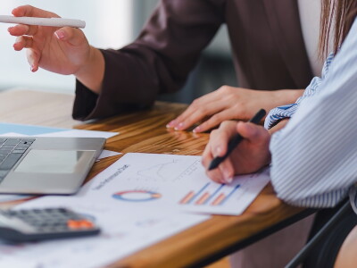 Two professionals analyzing business data on dashboard screen