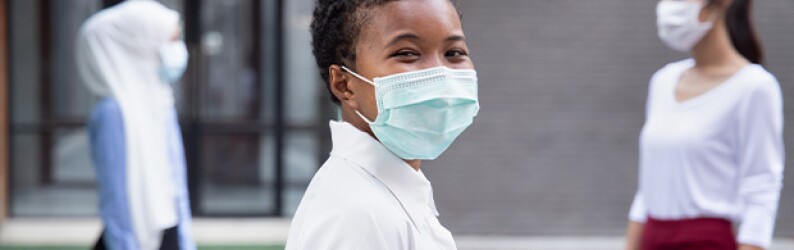 Happy woman wearing face mask, social distancing