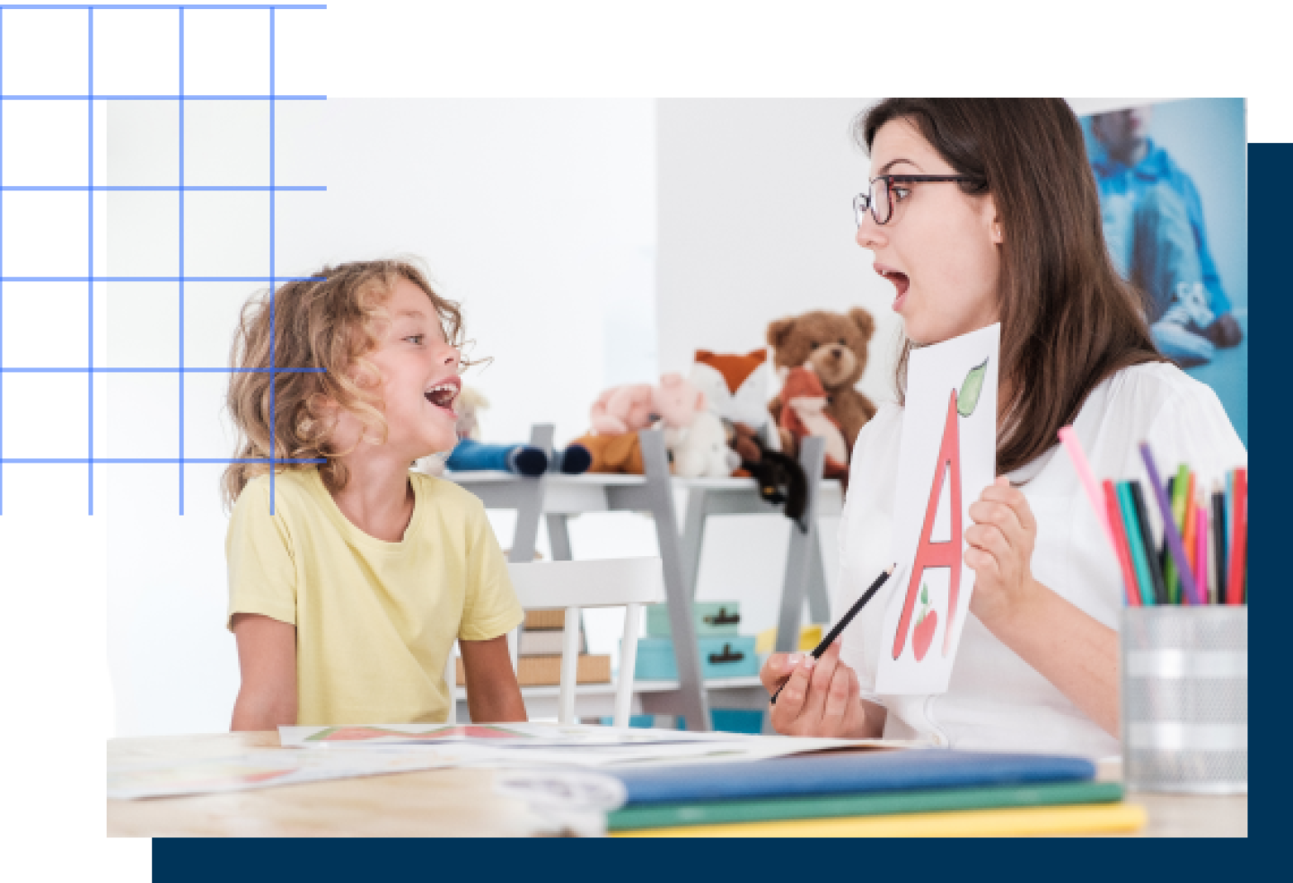 A female teacher works on an alphabet lesson with a female student.
