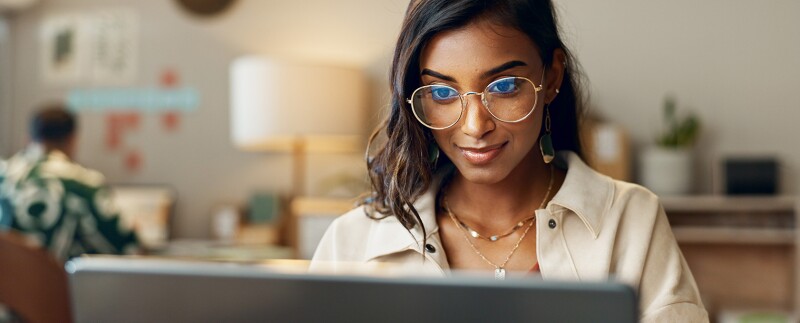 Business woman reading on laptop