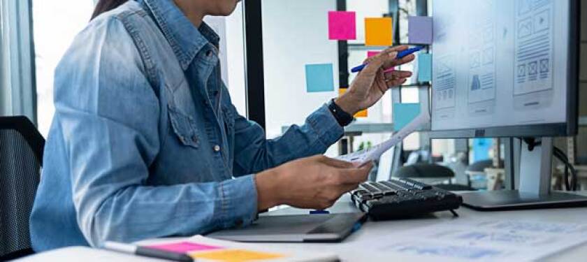 UX designer working on a computer to design a page layout