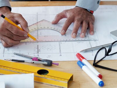 An engineer writing measurements on a piece of paper.