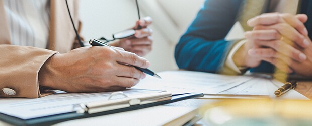 Sitting-at-desk-with-employee