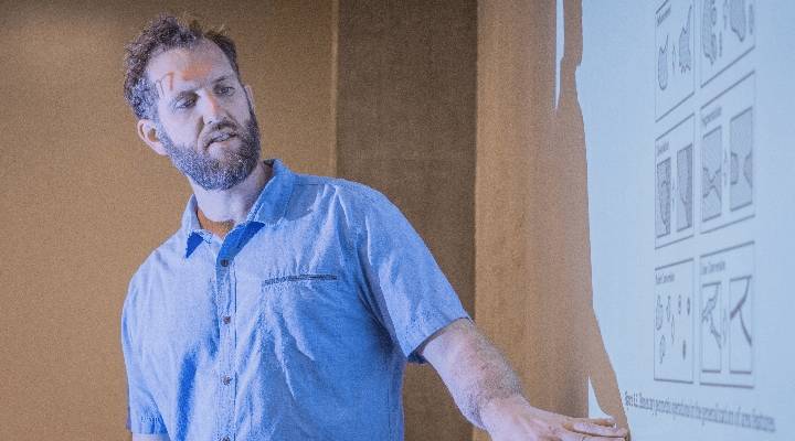 UC Merced instructor pointing at projection during class