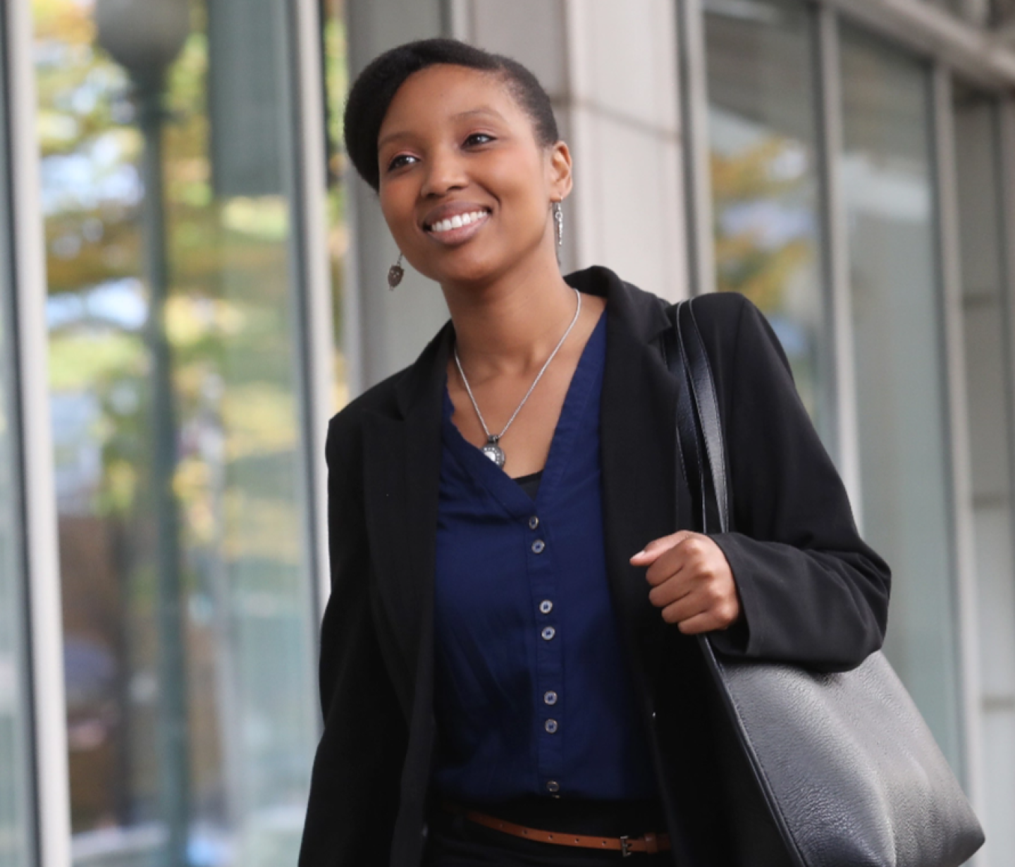Woman smiling with bag over shoulder