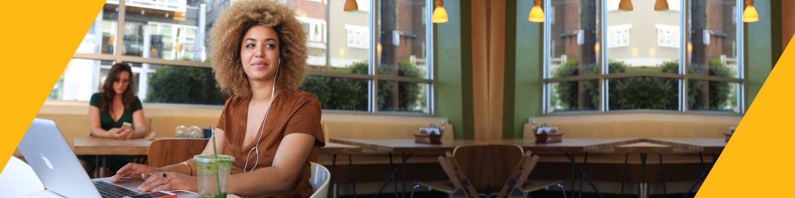 Student works on a laptop while sitting in a cafe