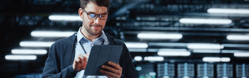 IT specialist using a tablet computer at a cloud computing facility