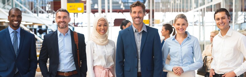 Diverse group of business people standing together in corridor at office