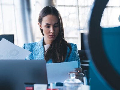 Woman sitting at desk reading a document
