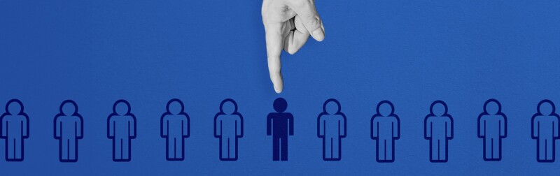 A hand selecting a figure from a lineup of people icons