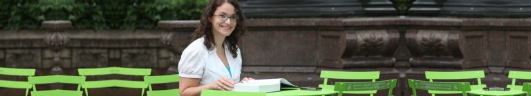 Student works at a table in NYC park