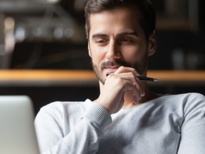 Man focused on reading computer screen
