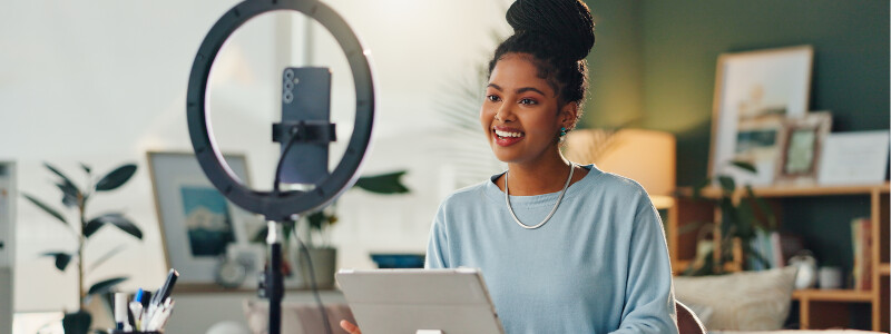 Female content creator sitting in a college dorm doing a podcast on personal branding