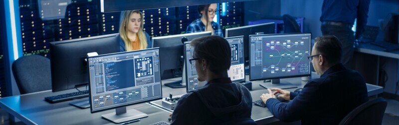 Team of IT Programers Working on Desktop Computers in Data Center System Control Room.