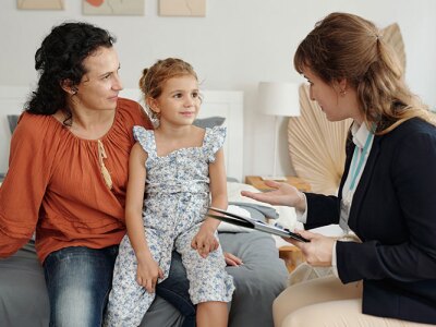 A parent and child interacting with a counselor