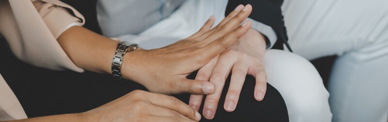 Employee woman defending at hand of colleague touching her knee