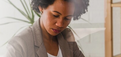 Woman in office looking down at her work