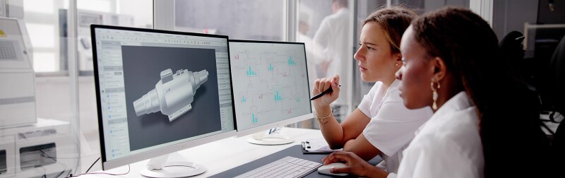 Mechanical engineers designing machine parts on a computer