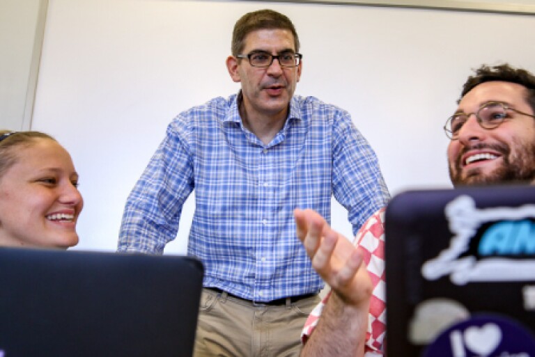 Teacher with students on laptops