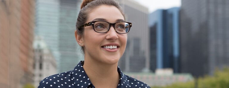 Woman standing outside KU University smiling