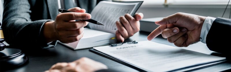 Close up of human resource lawyers discussing business agreement at law firm office