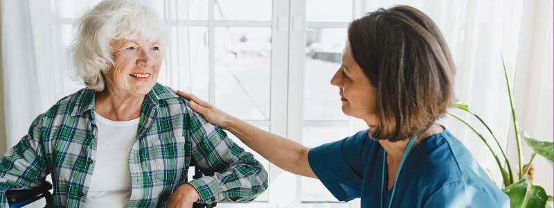 An allied health professional sits in conversation with her patient