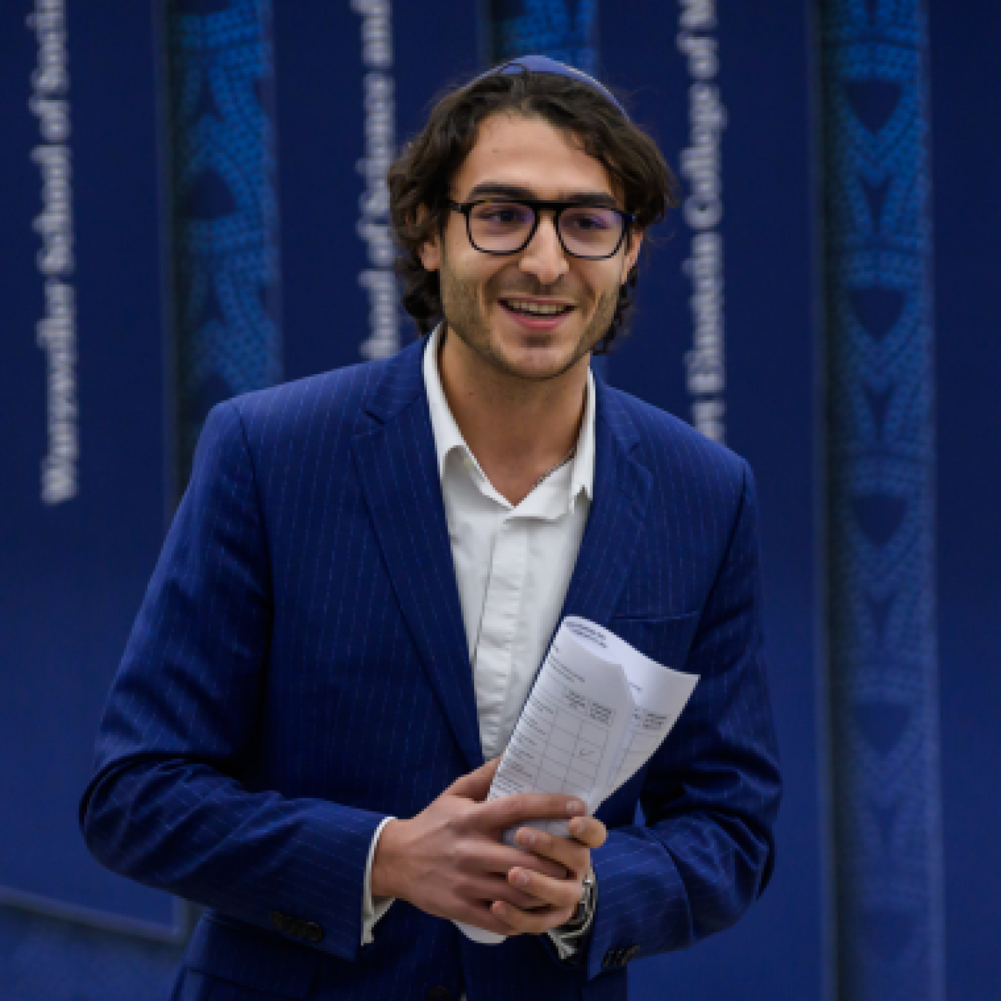 A male Yeshiva University professor answers questions at a live event.