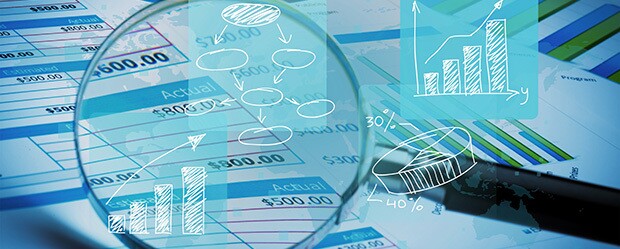 magnifying glass looking at numbers for forensic accounting