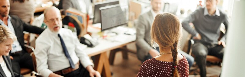 professor in polka dot top lecturing a class in professional development