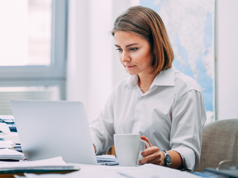 lady working at desk with coffee cup