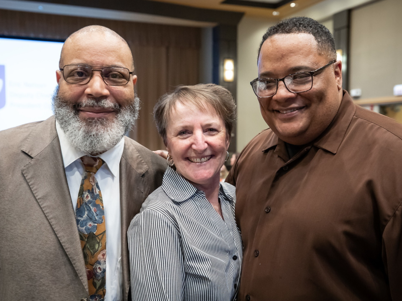 Three DePaul faculty members facing camera smiling