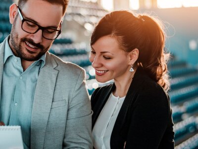 Two sport managers organizing an event in sport hall.