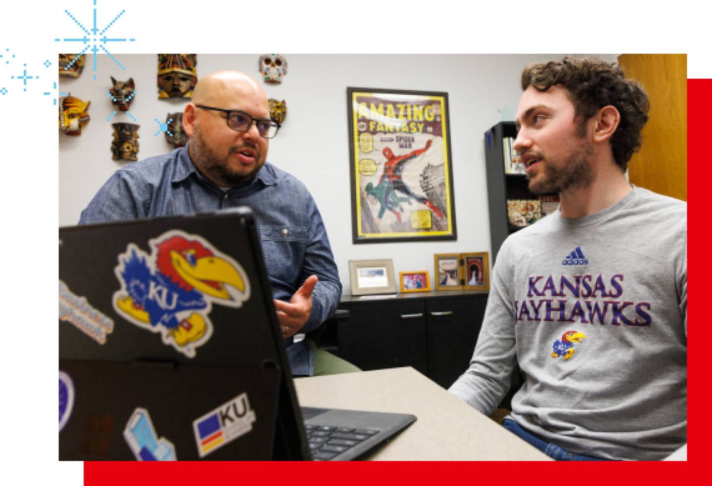 A male KU professor is conducting a study review with a male KU student.