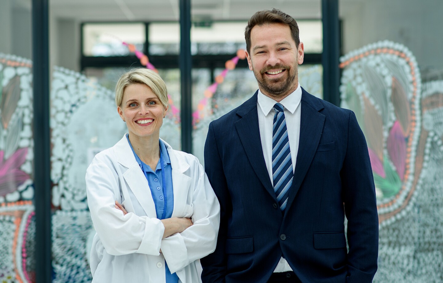 Male hospital manager standing next to female doctor