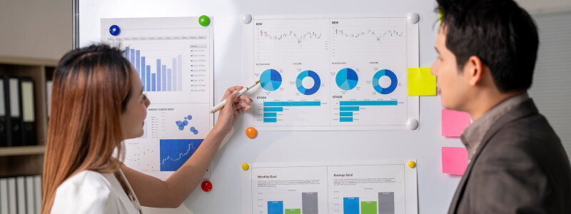 Two colleagues review business metrics together