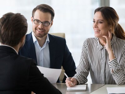 A group of people sitting at a conference table