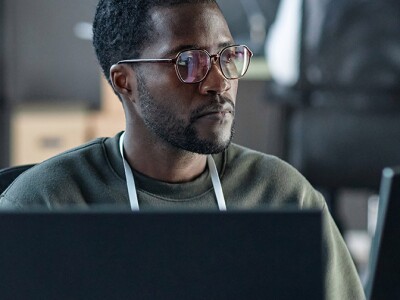 Man at computer accessing cybersecurity risk