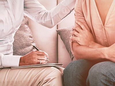 counselor and patient speak while the counselor takes notes