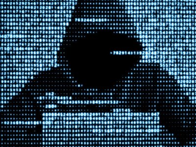 Hacker using laptop to conduct DoS attacks.