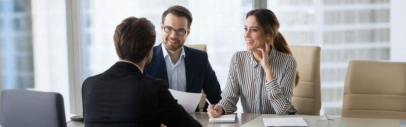 A group of people sitting at a conference table