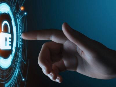 Student's hand pressing a lock icon in a virtual cyber security data protection business technology program.