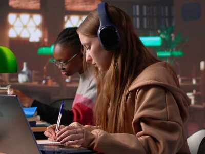 College students sitting at their desk in a classroom participating in an online webinar course about law