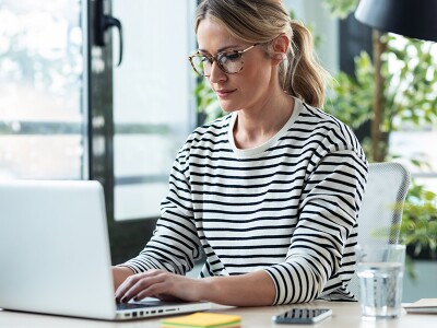 Woman working on her laptop at home