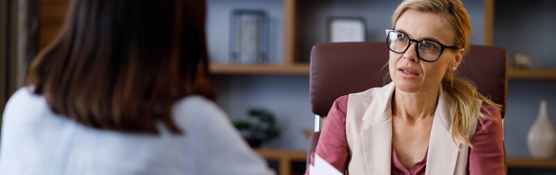 Female career counselor talking to young professional