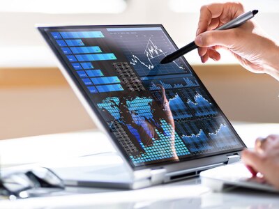 Business women working on a laptop with a KPI Business Data Dashboard Analytics.