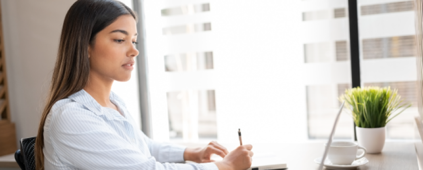 Professional woman working on laptop at her desk