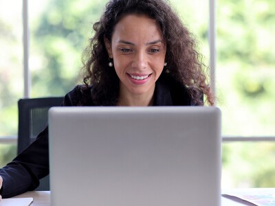 Woman studying on her laptop in her home office