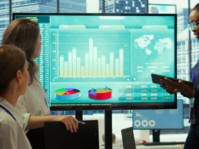 Business team presenting infographics and digital marketing insights for growth, showcasing the impact of recent campaigns and outlining plans for future development initiatives in workspace.