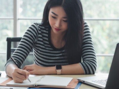 Woman studying focused at her desk