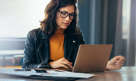 Woman working on her laptop at a table